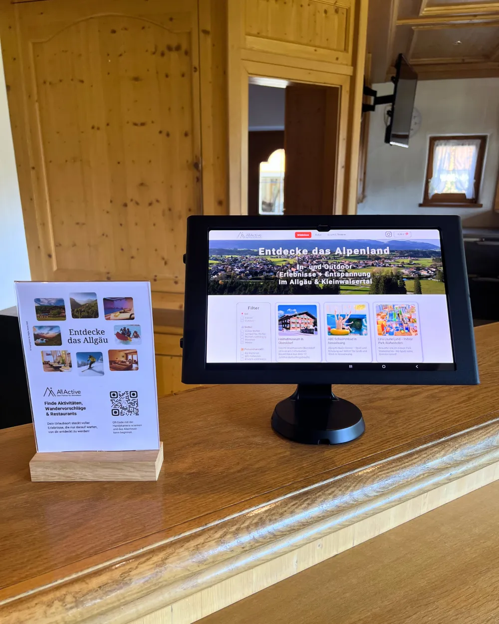 Erlebnis-Tablet auf dem Holztresen einer Rezeption